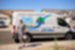 A water treatment expert walking from his company van